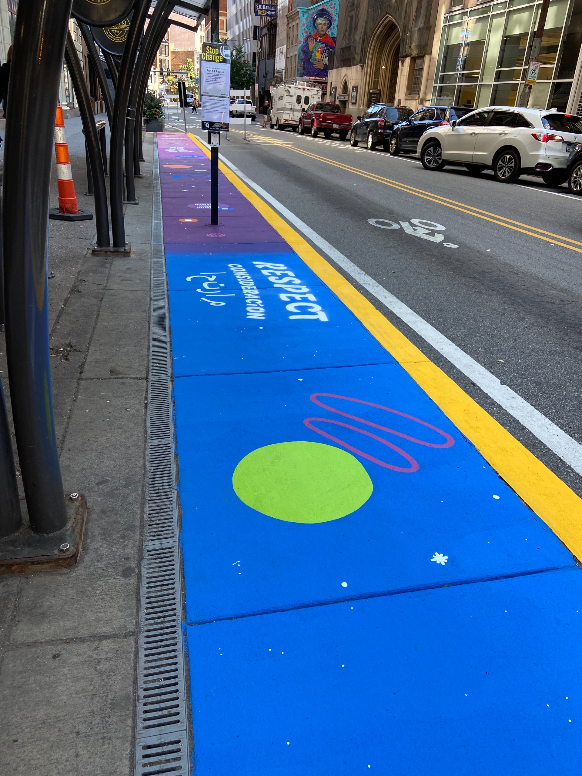 A blue painted sidewalk with a green circle
